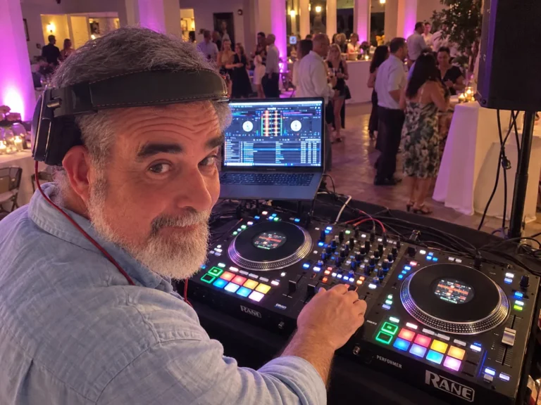 DJ 2RO at a Rane Performer during an evening patio party with purple uplighting