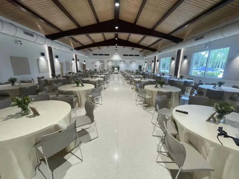 Banquet hall set with round tables and centerpieces before an event
