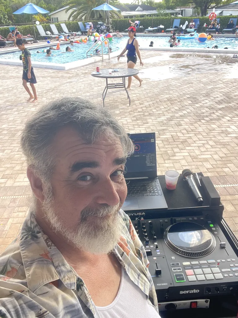 DJ 2RO at the controller during a poolside party
