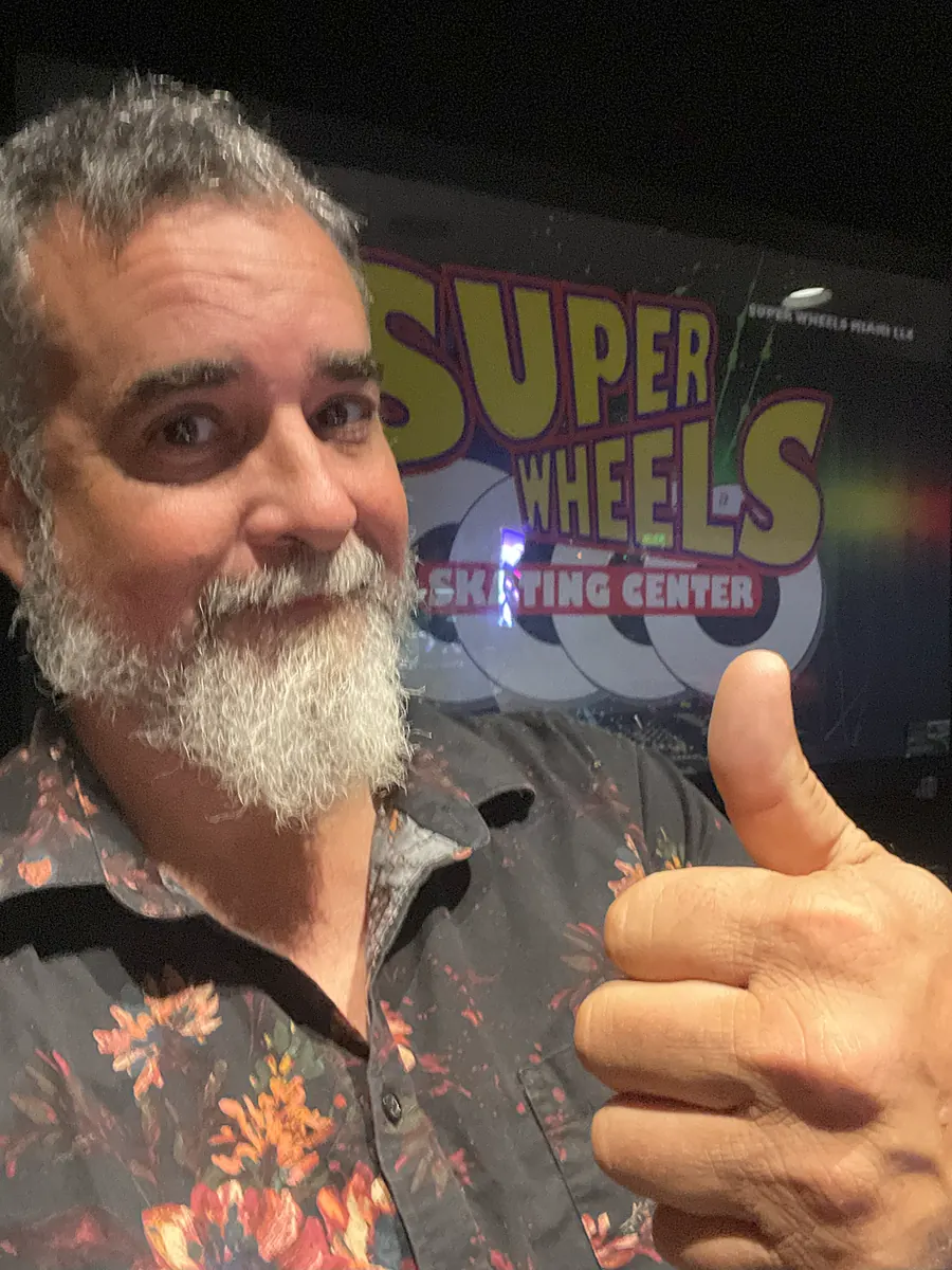 DJ 2RO, Arturo Morejon, giving a thumbs-up at Super Wheels Skating Center